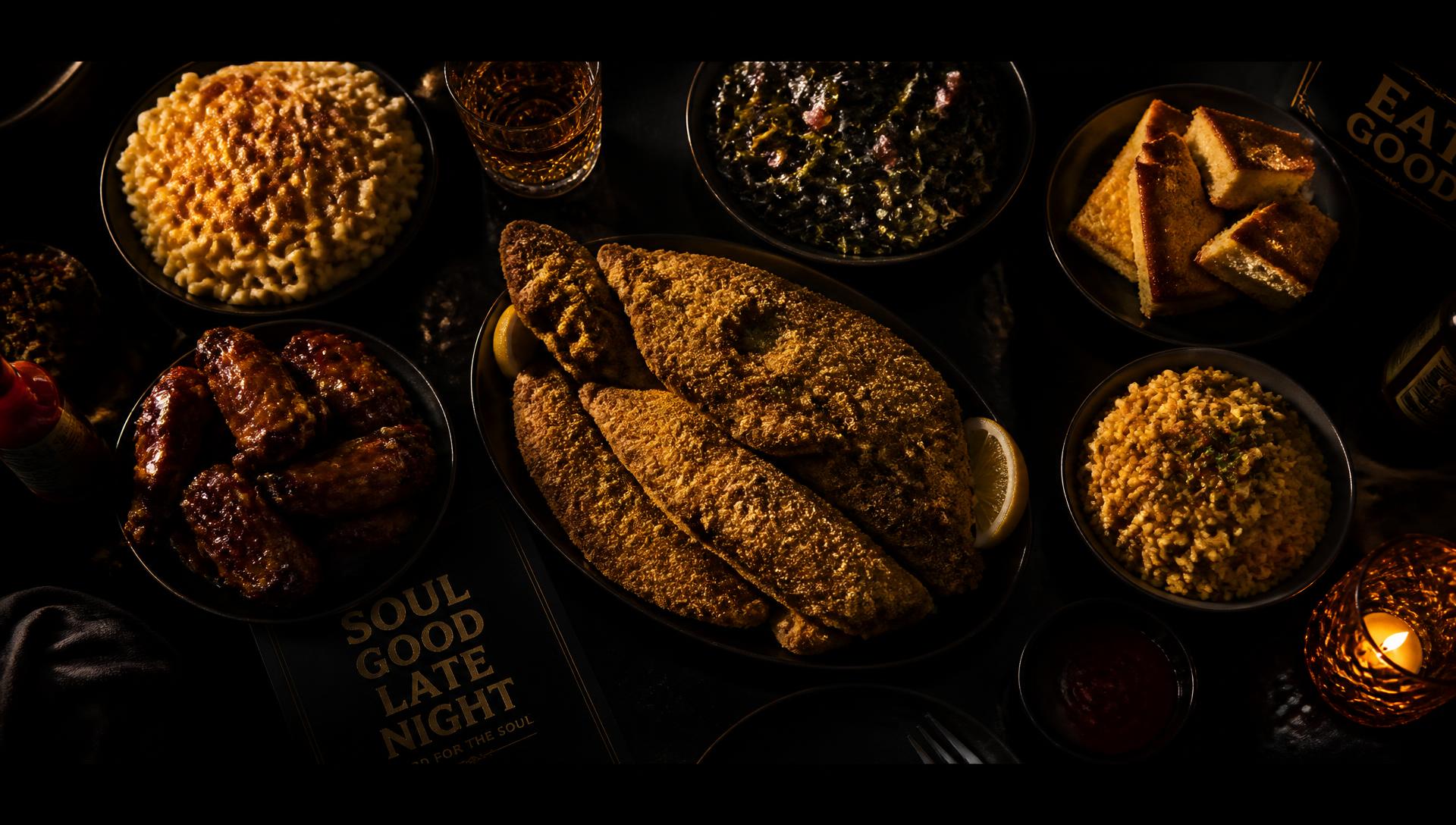 Spread of soul food plates on a dark table